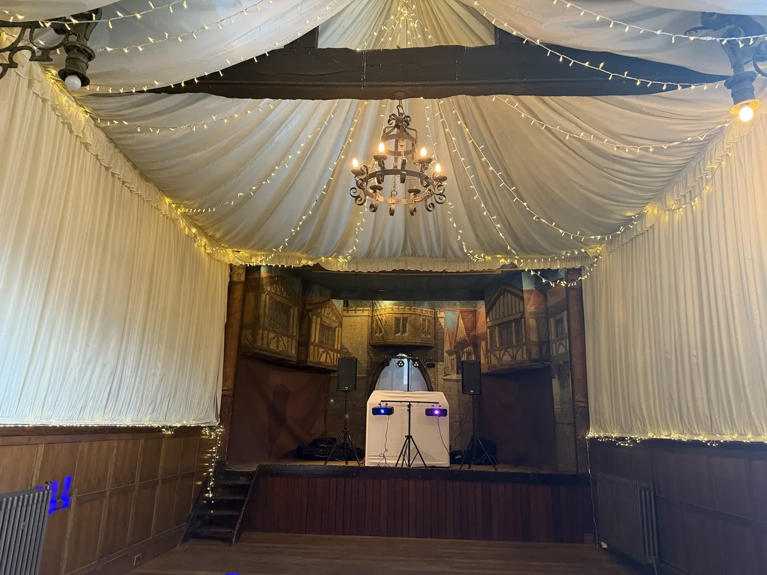 Close view of the Hurricane Roadshow white DJ stand with speakers and lighting at How Caple Court